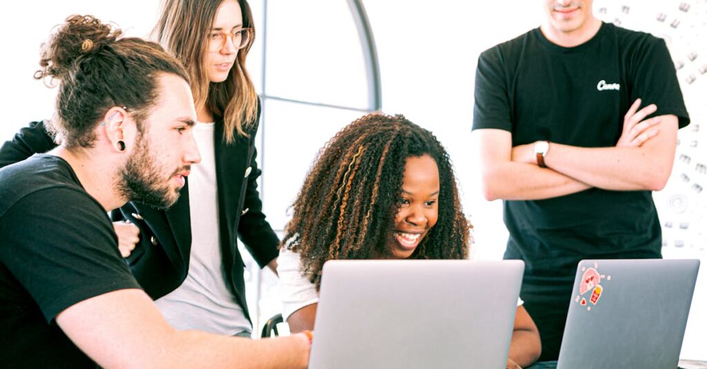 A diverse group of young professionals collaborating enthusiastically in a bright, modern workspace.