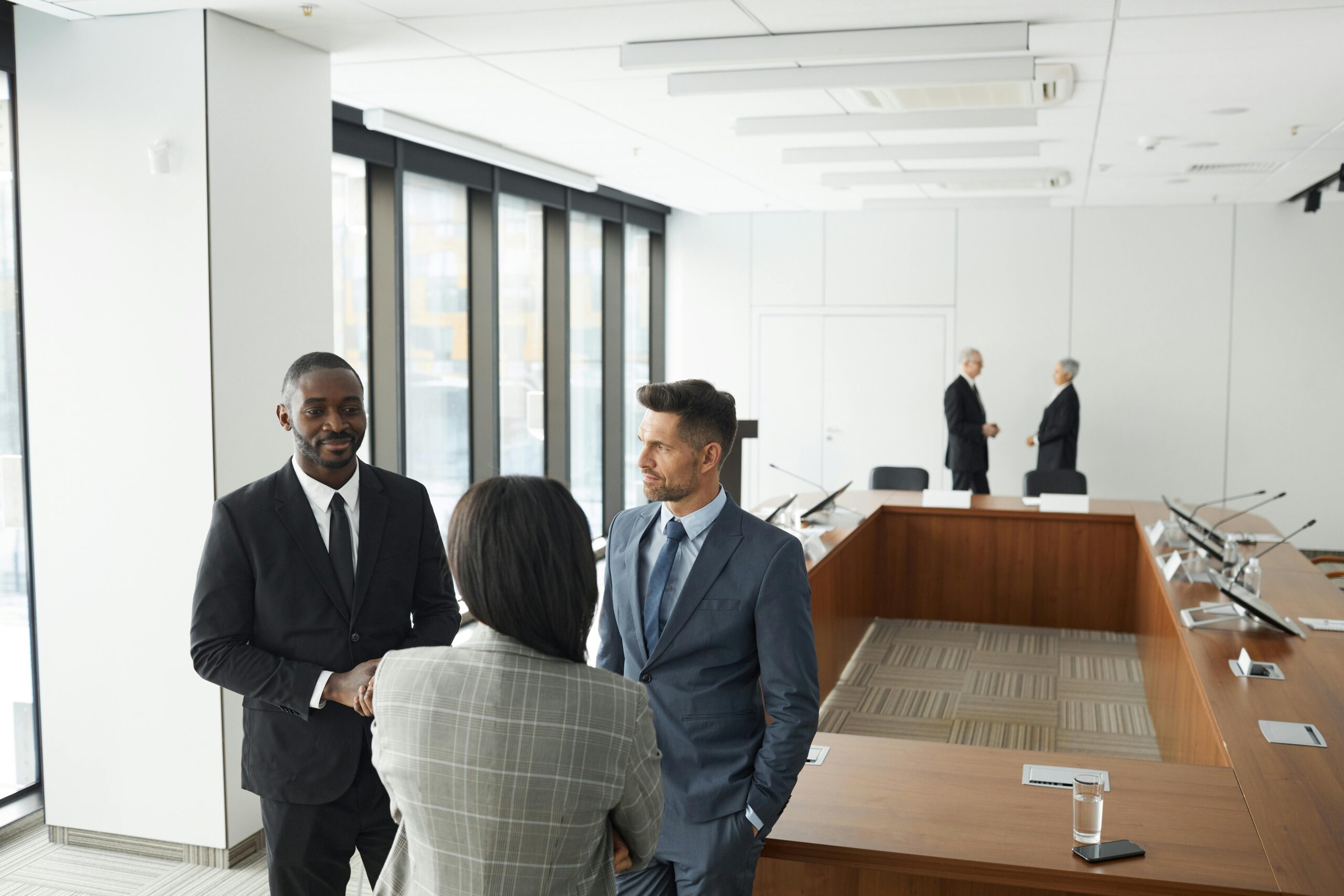 Business professionals engaging in a meeting in a modern conference room.